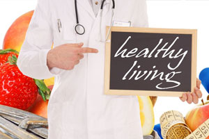 Dr pointing to a chalkboard with the text that reads Healthy Living