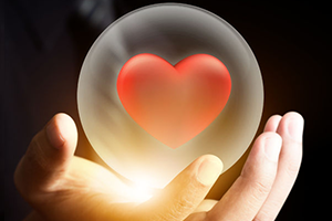 Picture of Heart in a Crystal Ball being held by a hand.